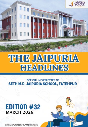 Front view of a modern school building with an orange banner reading 'THE JAIPURIA HEADLINES' and cartoon students at the bottom announcing Edition #32, March 2026.